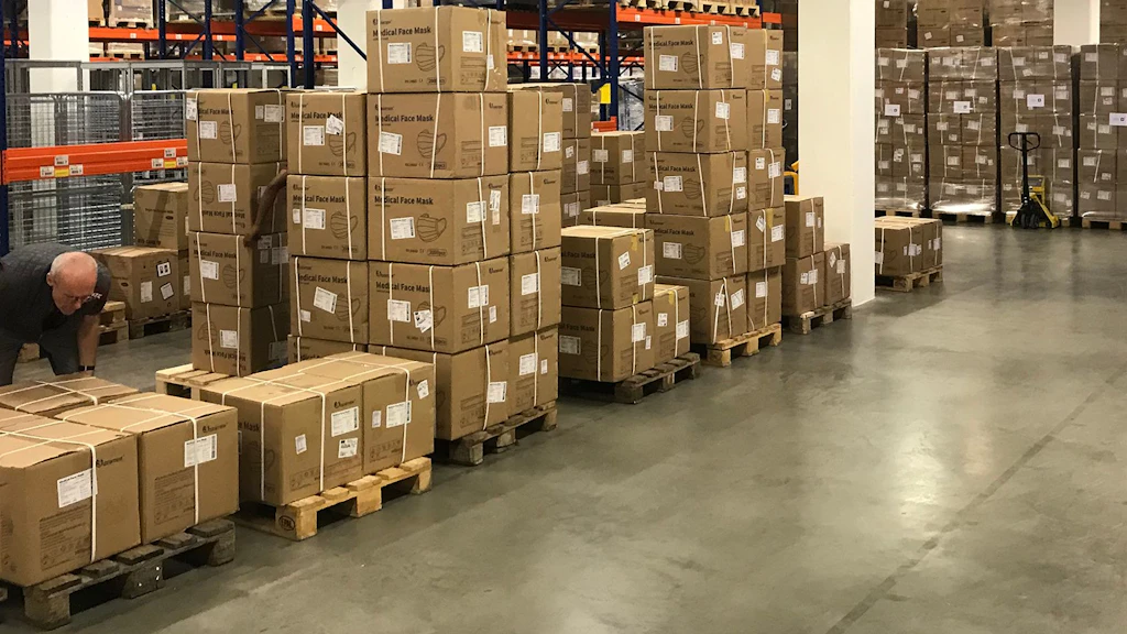 View into the depot of the Humanitarian Aid with boxes stacked on transport pallets.