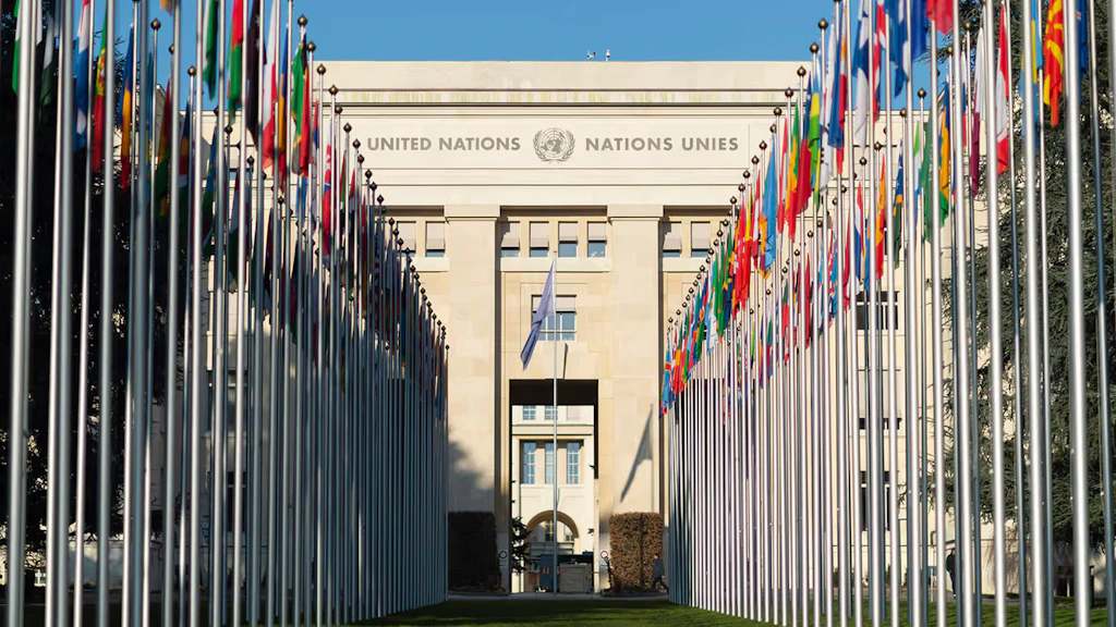 Member States' flags raised in front of the Palais des Nations in Geneva.