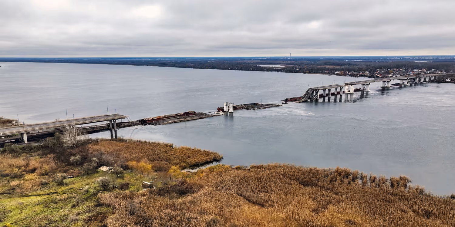 A damaged bridge over a river, with parts of its carriageway lying in the water.