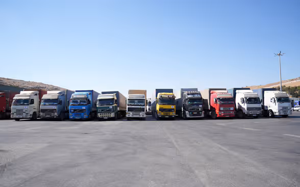Eleven lorries packed with humanitarian aid for Syrian civilians are ready to leave the Bab al-Hawa crossing point on the Turkish-Syrian border.