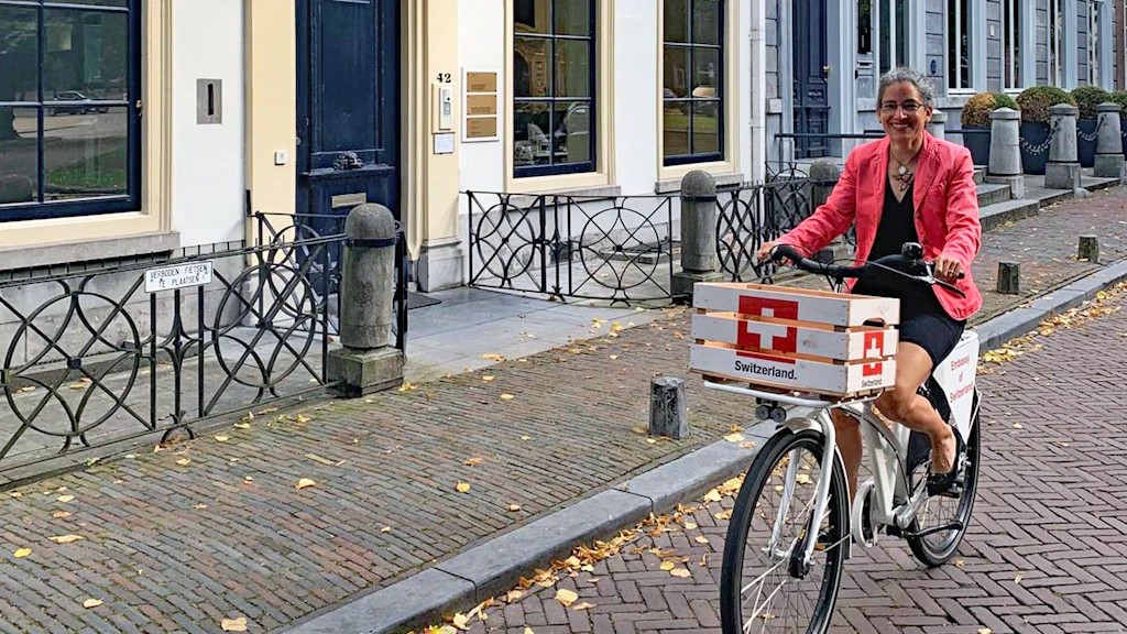 A woman riding her bicycle in The Hague.