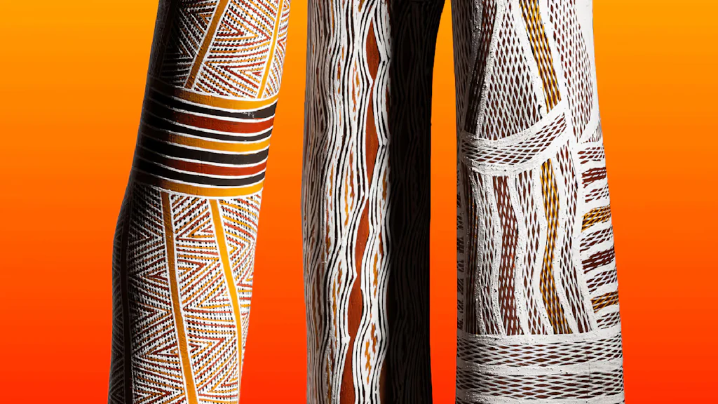 alt="Three brightly painted yidakis shown against a yellow background, with the words 'Breath of Life' superimposed on them."