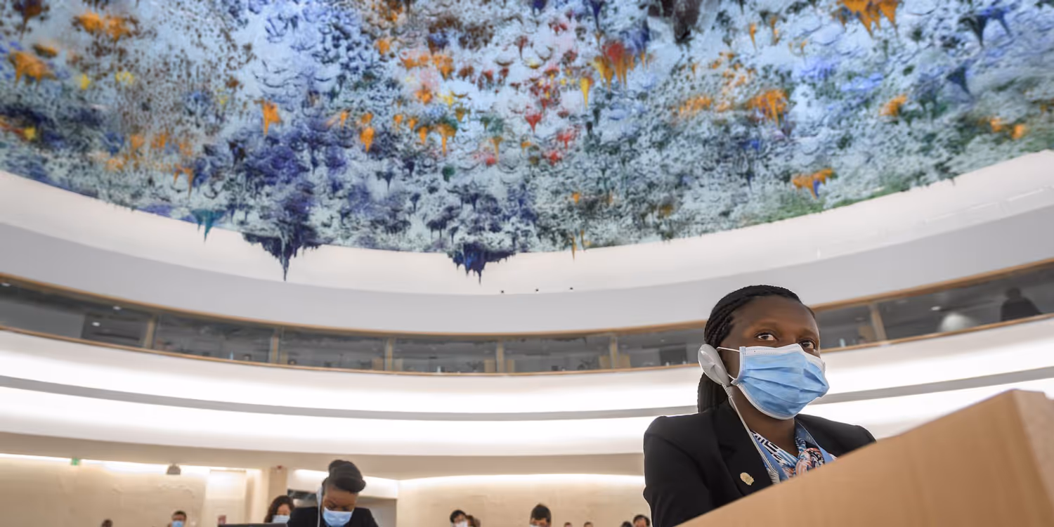 A woman uses a translation device to listen to a speaker during the session of the UN Human Rights Council.