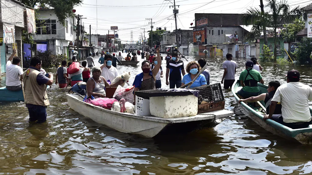 Inhabitants crossing an avenue flooded by heavy rains following the passage of hurricane Eta.