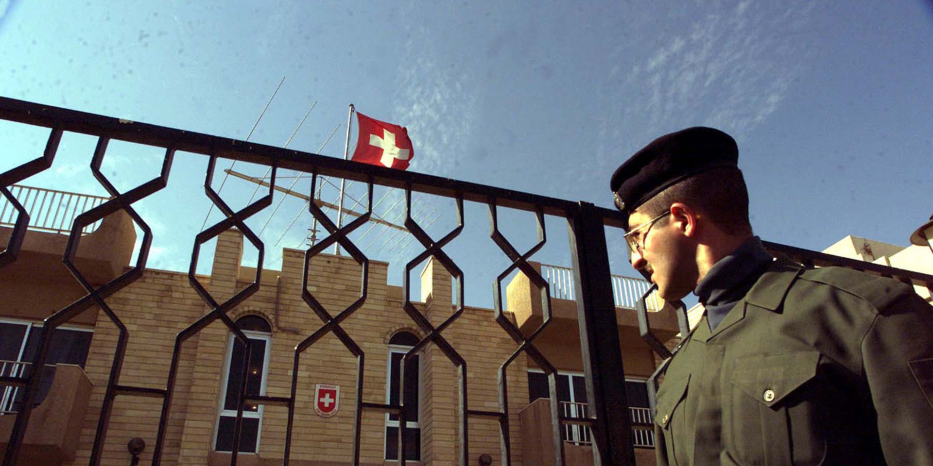 An Iraqi police officer at the gates of the former Swiss embassy in Baghdad.
