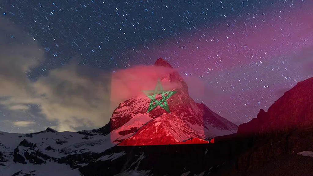 Morocco's red and green flag being projected onto the iconic Swiss mountain.