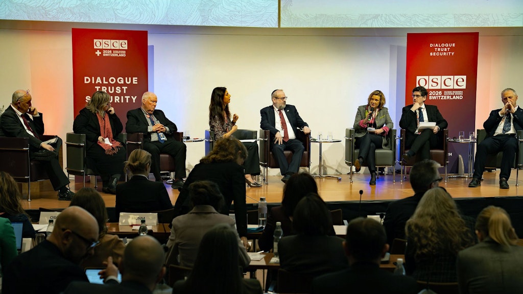 Eight people speak during a panel discussion at the conference on combating anti-Semitism in St. Gallen.