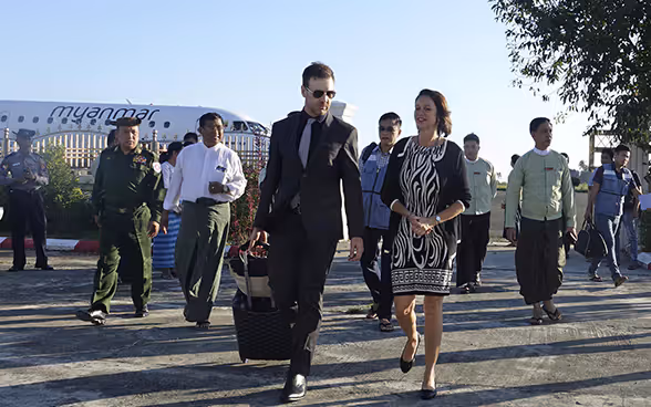 A Swiss diplomat leaves a plane in Myanmar with her delegation