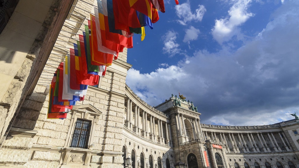 The flags of the 57 participating States hang in a row on the outer wall of the building in Vienna where the OSCE has its headquarters.