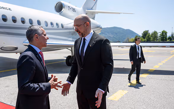 Ignazio Cassis speaks at Agno Airport with Ukrainian Prime Minister Denys Shmyhal.