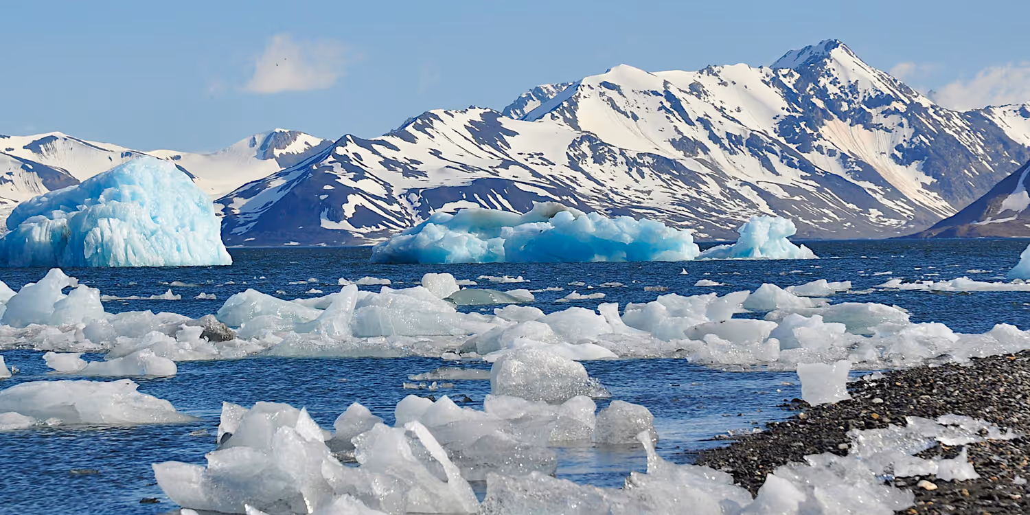A group of icebergs floating above a body of water.