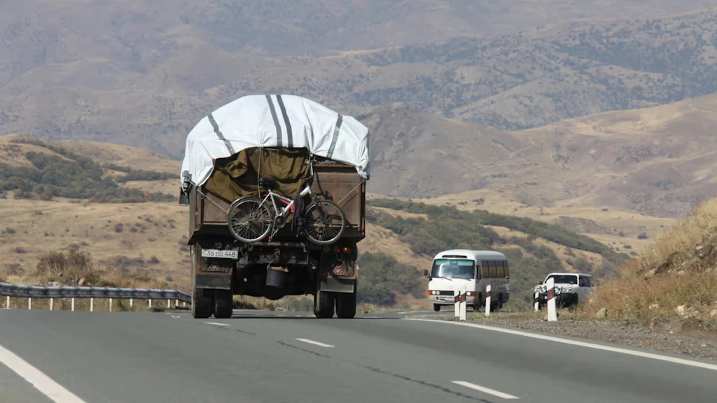 A truck carrying a bicycle drives towards Armenia from Nagorno-Karabakh.
