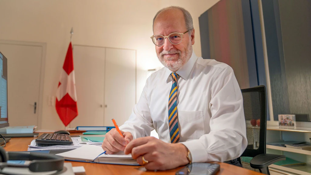 State Secretary Alexandre Fasel sitting at a desk.