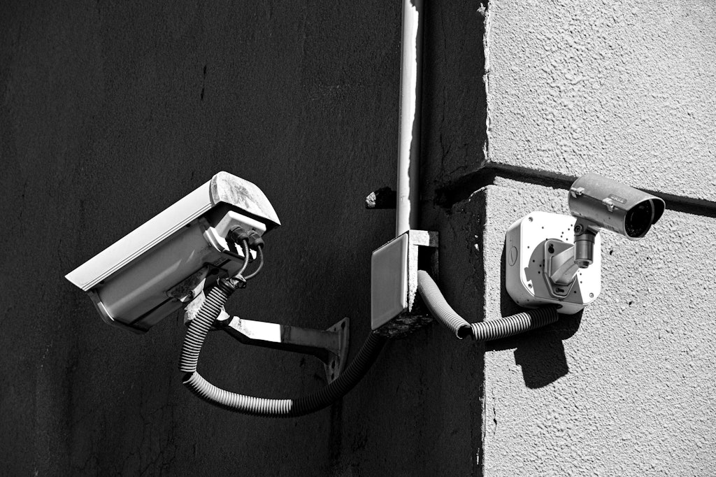 A surveillance camera on a wall.