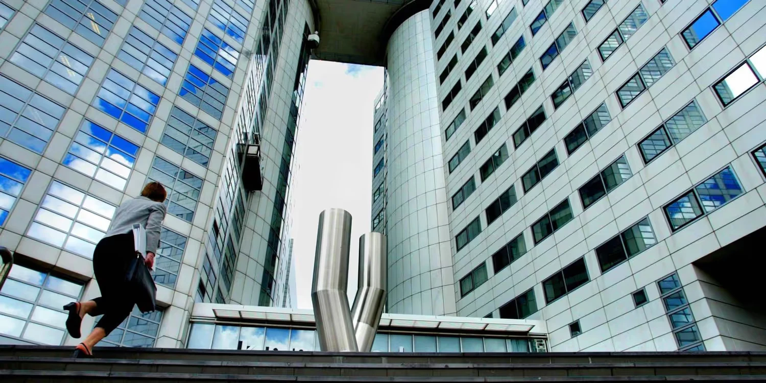 A woman is climbing the stairs of the ICC in Den Haag.