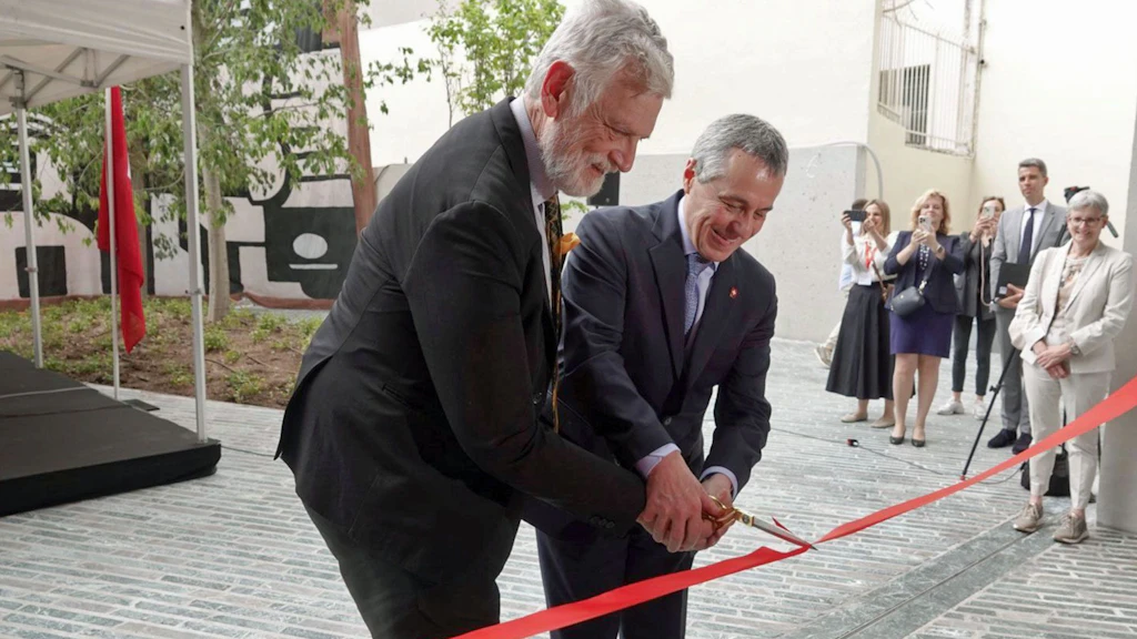 Le chef du DFAE Ignazio Cassis et son homologue Ioannis-Michail Loverdos coupent un ruban rouge avec un ciseau.